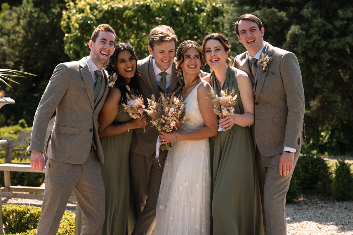group photo of becca and fred and their bridal party at the secret garden in kent