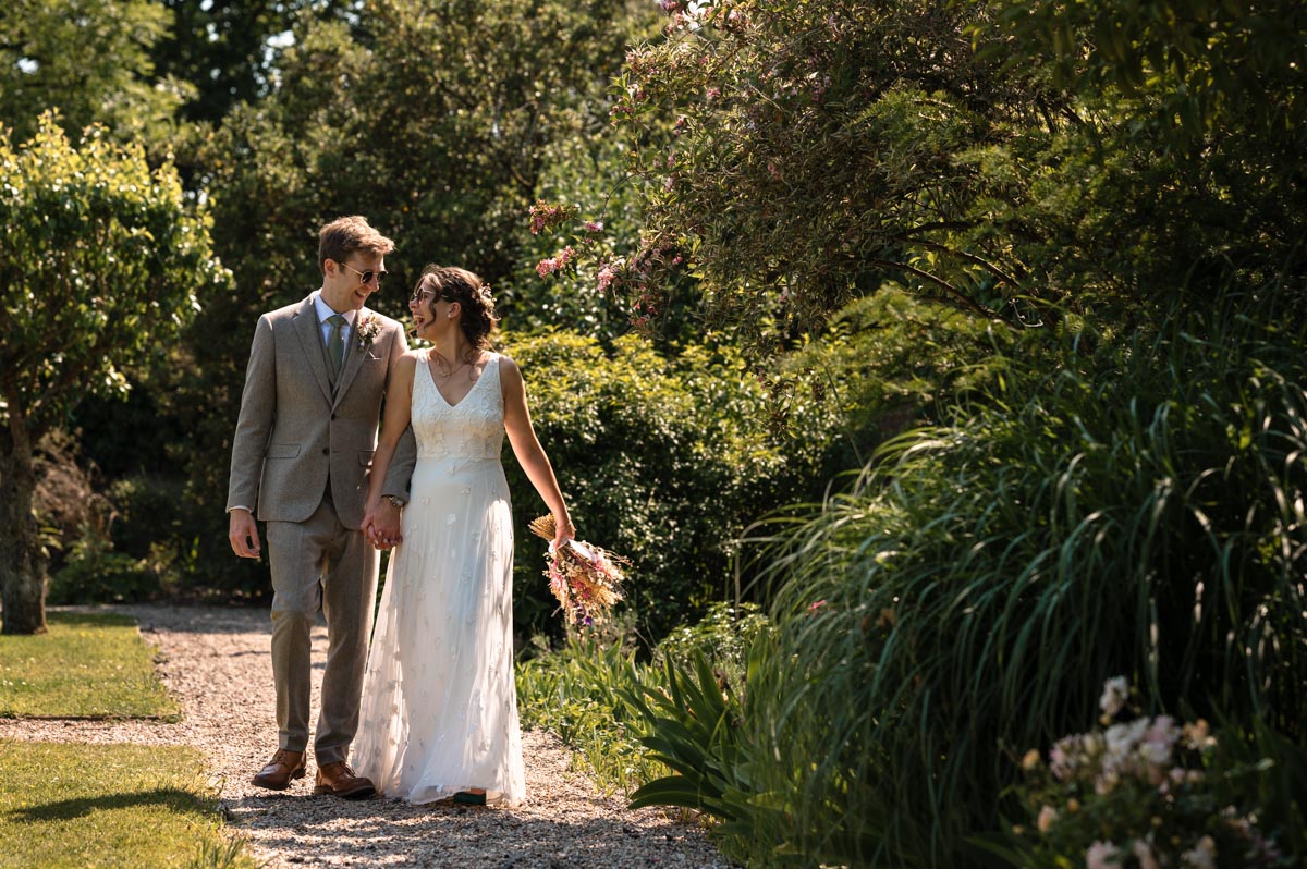 secret garden wedding photography, becca and fred walk in the gardens together