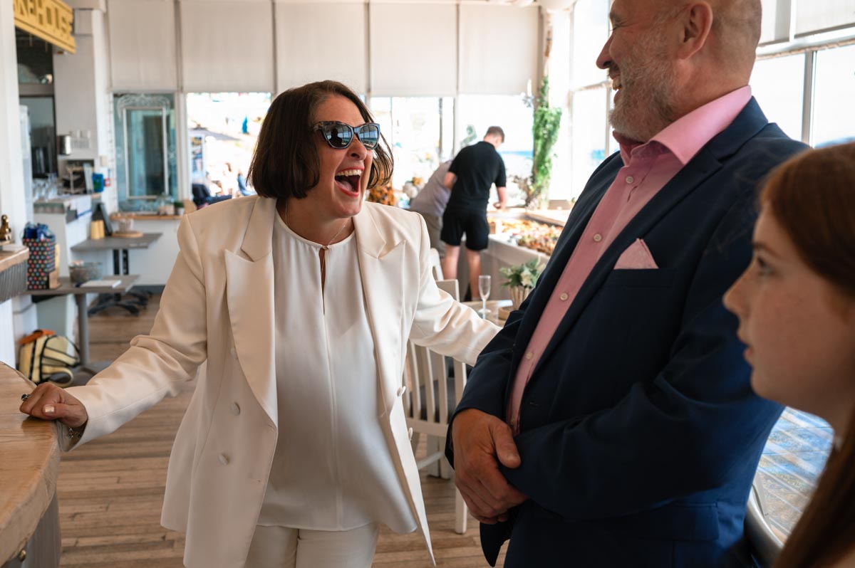 Donna laughing with wedding guest at her east Sussex wedding reception