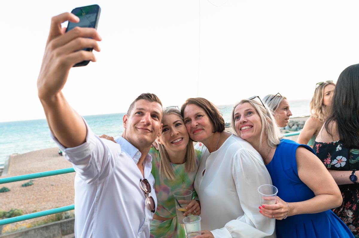 Guests and bride and take a selfie at wedding in Brighton
