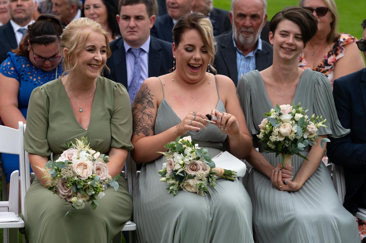 Westenhanger castle wedding photography - lara bridesmaids laughing together