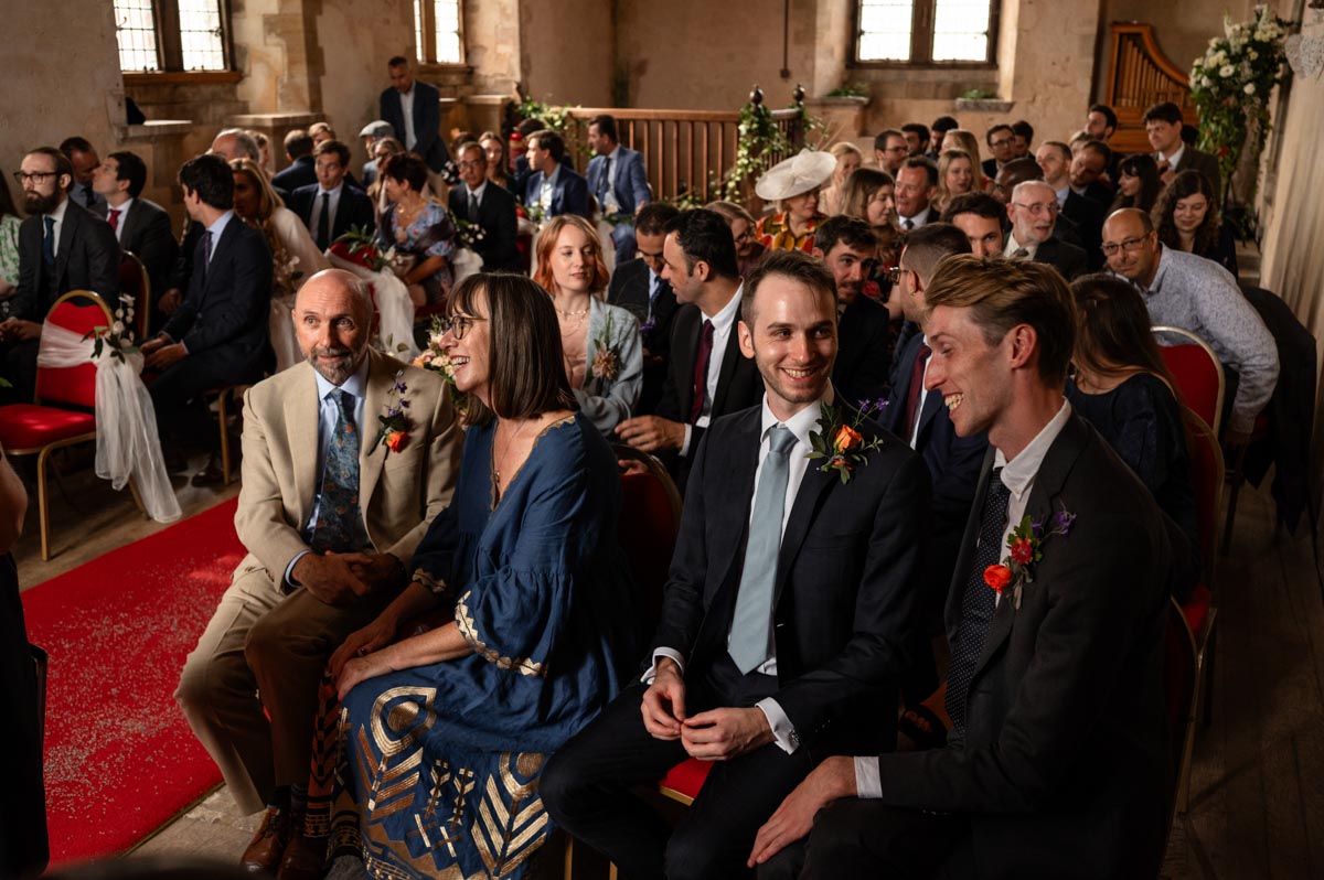 Bilsington Priory wedding photography. Photograph of wedding guests during the ceremony