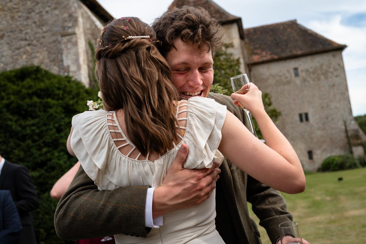 Poppy hugs friend at her wedding at Bilsington Priory wedding venue