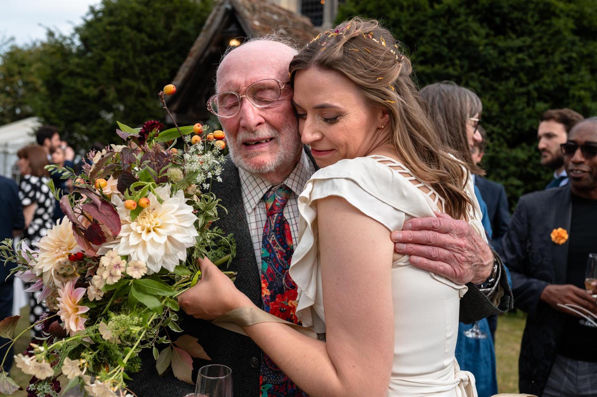 Poppy and her granddad embrace at her wedding at Bilsington Priory