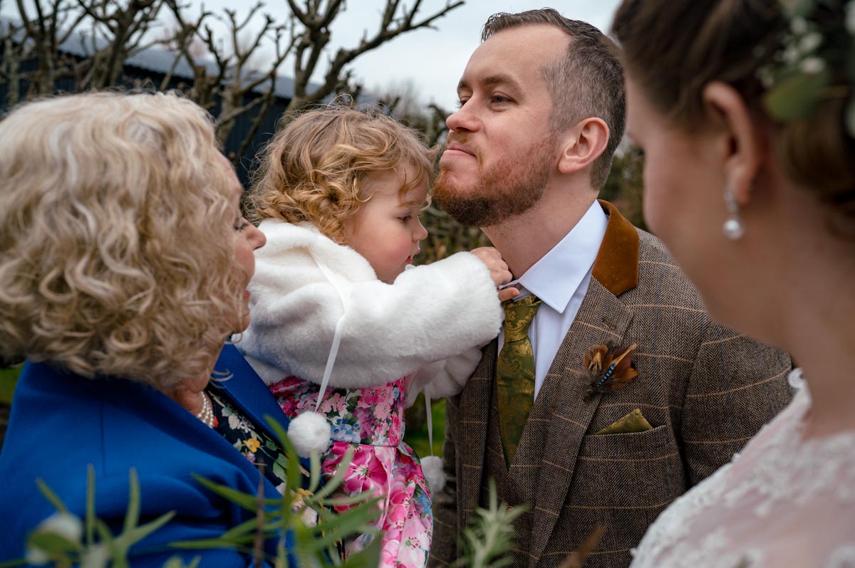 Spring wedding photography at the secret garden in kent. Jacob has confetti put down his shirt