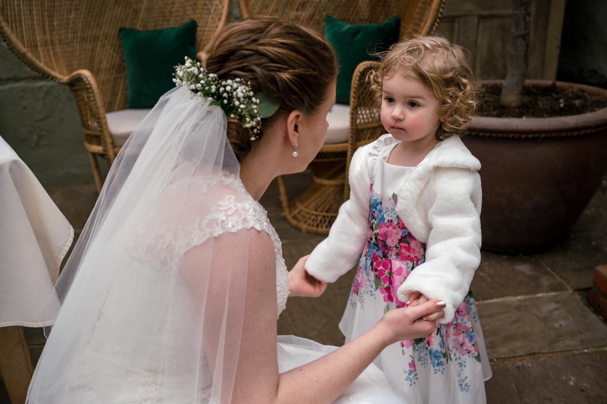 Bride and her daughter at her wedding at the secret garden in the spring