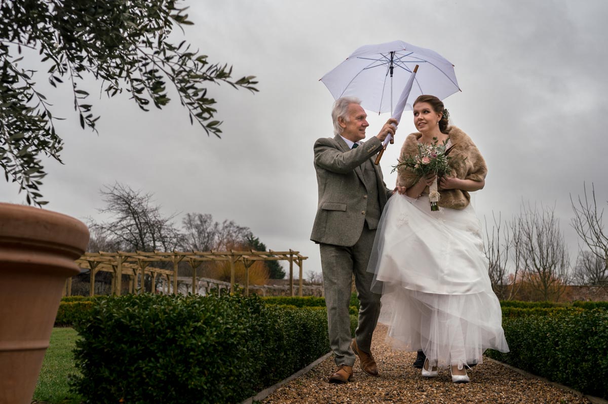 Laura and father walk through The Secret garden for her wedding ceremony in the Glass House