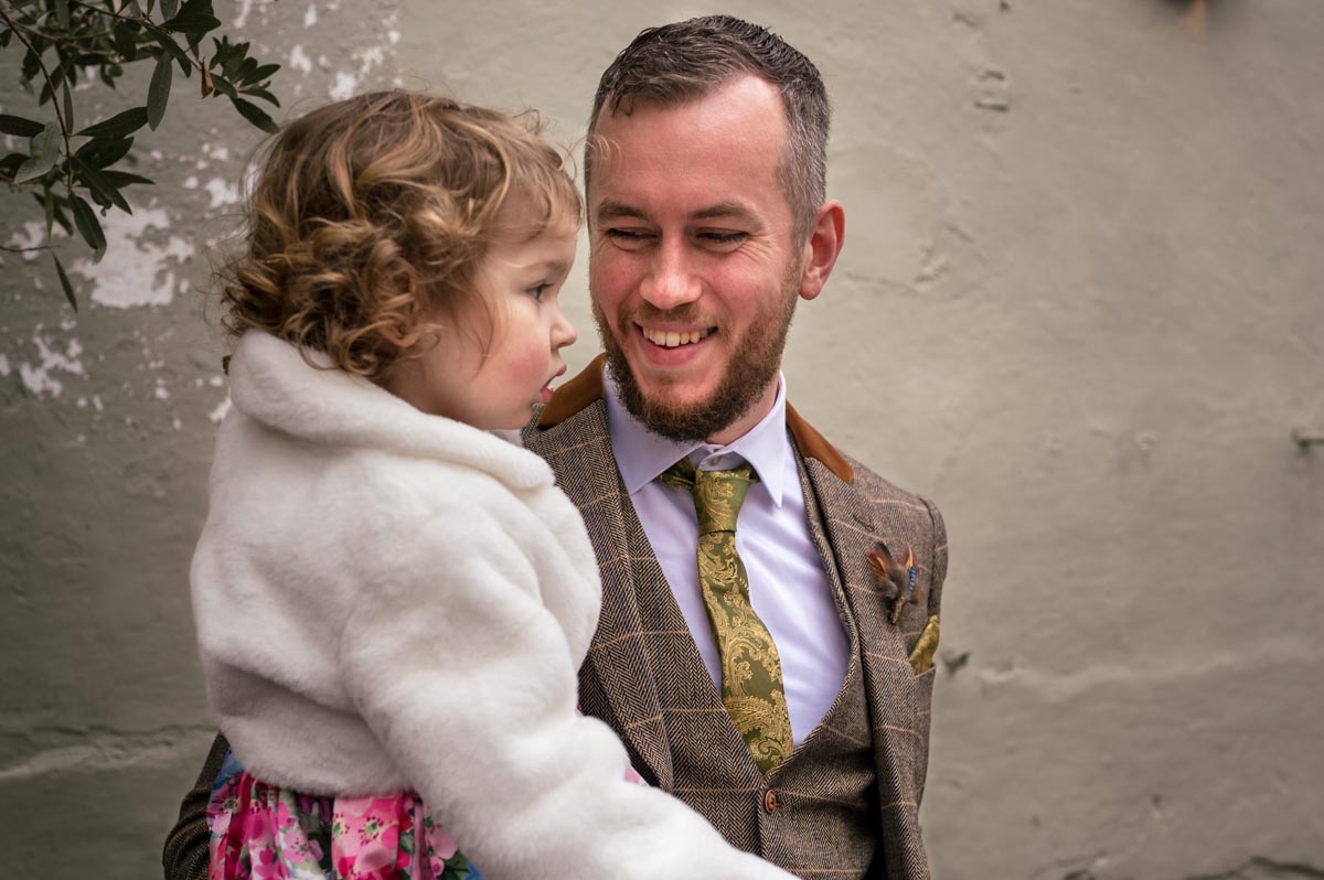 The secret garden wedding photography. Jacob with his daughter during the ceremony