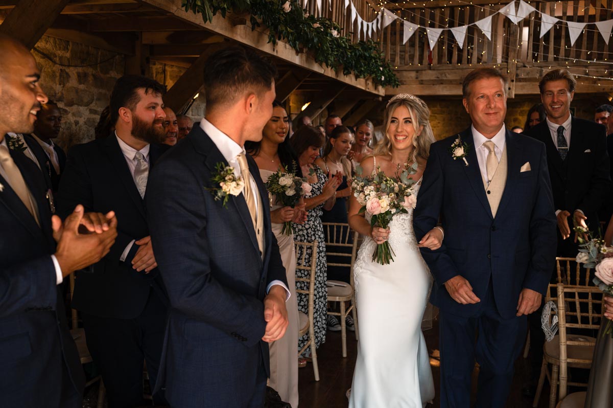 Bride and father walk down the aisle at Swallows Oast in ticehurst