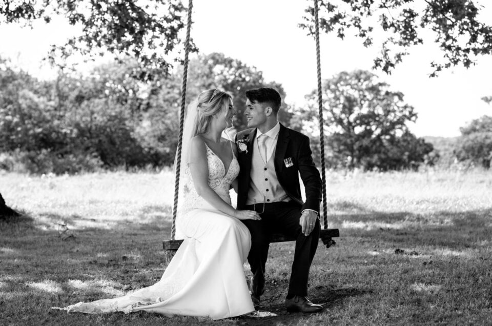 swallows oast wedding. Bride and groom photographed on swing