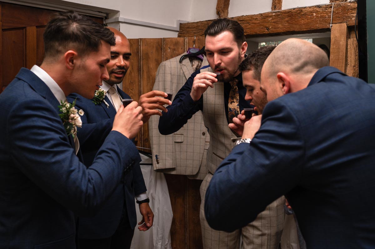 Groom and his groomsmen have a drink before his swallows oast wedding