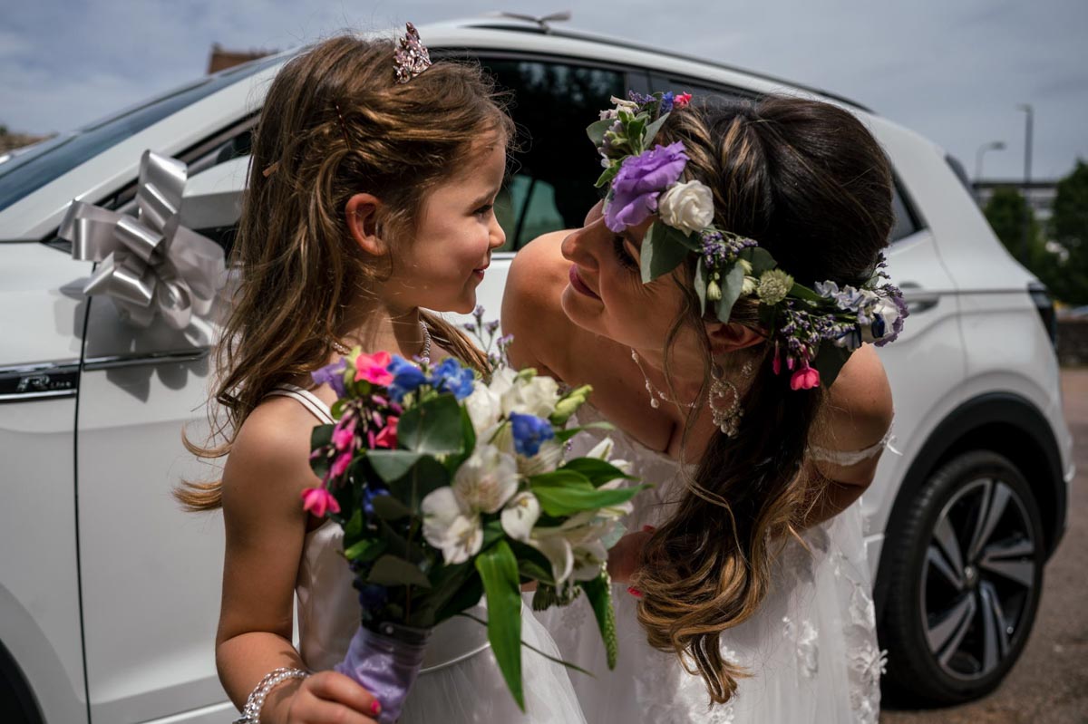 Bride has shares a smile with her daughter the flower girl.