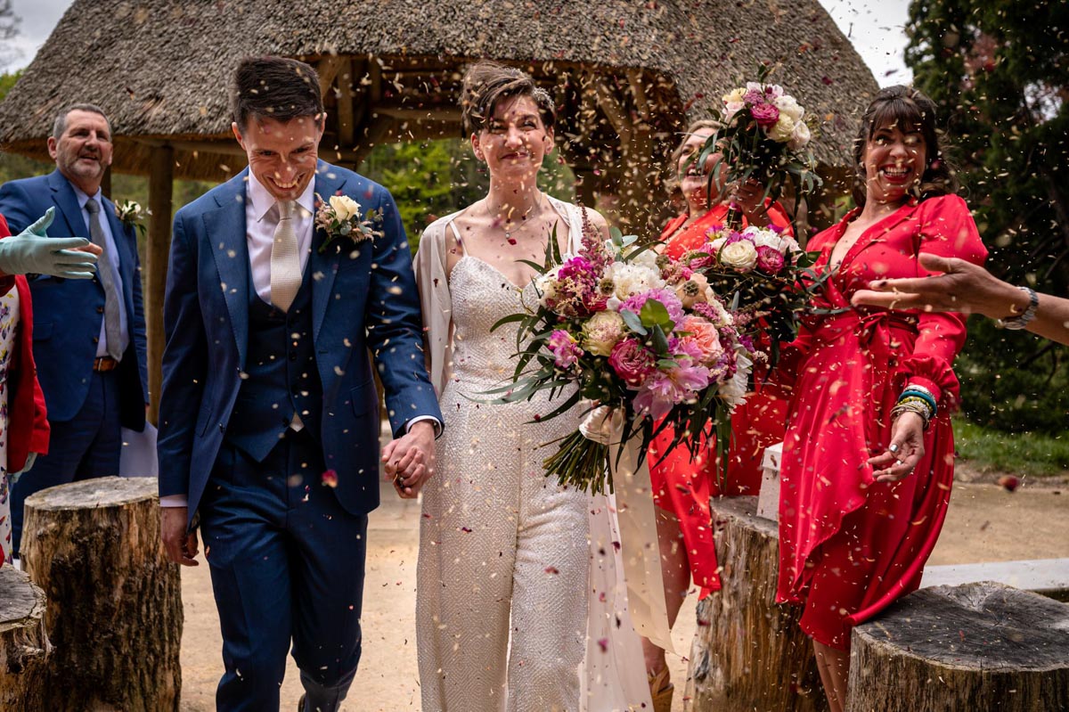 Outdoor wedding ceremony at The Orangery, maidstone. Groom and bride confetti photograph