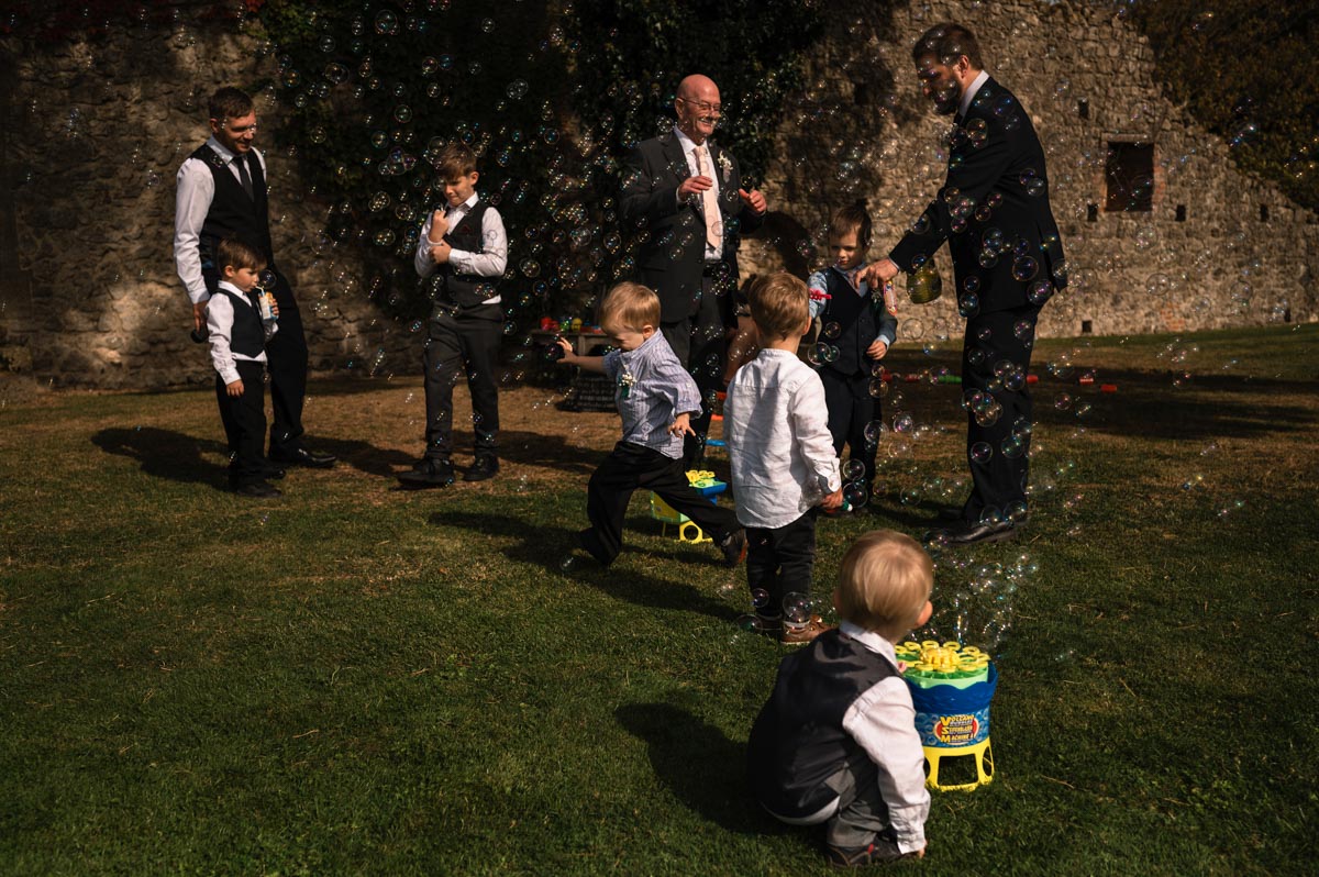 children photographed playing in bubbles at westenhanger castle wedding